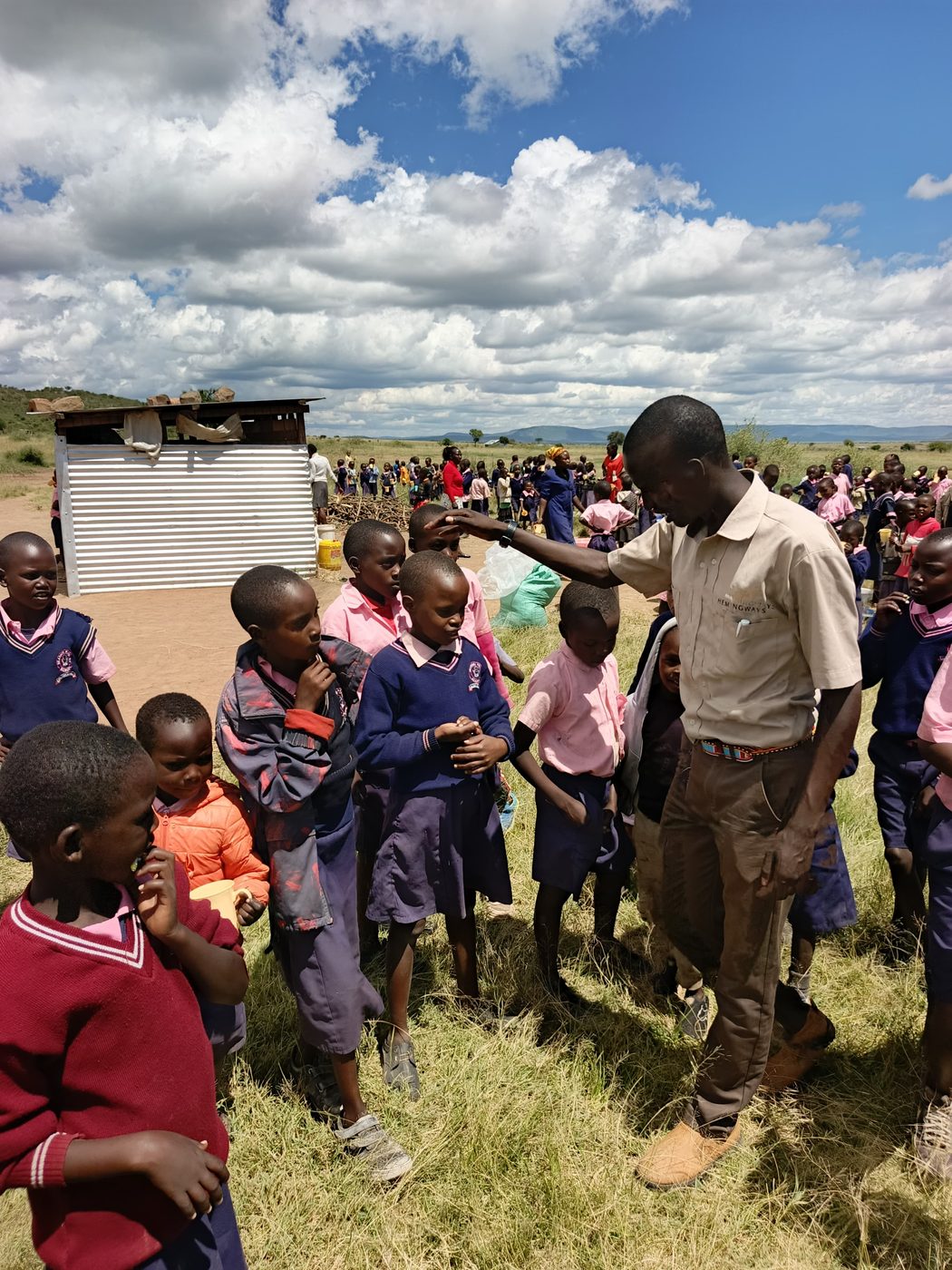 An ITF volunteer greeting schoolchildren during an outreach day