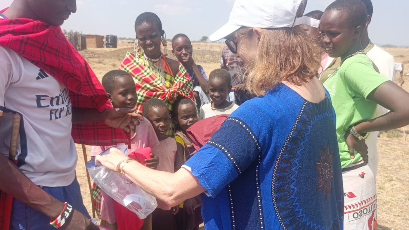 A partner volunteer engaging with a group of children